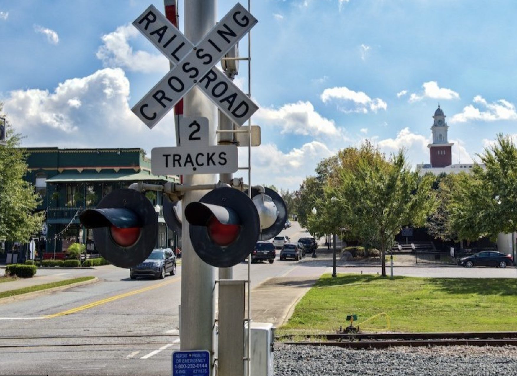 a view of downtown opelika with a railroad sign
