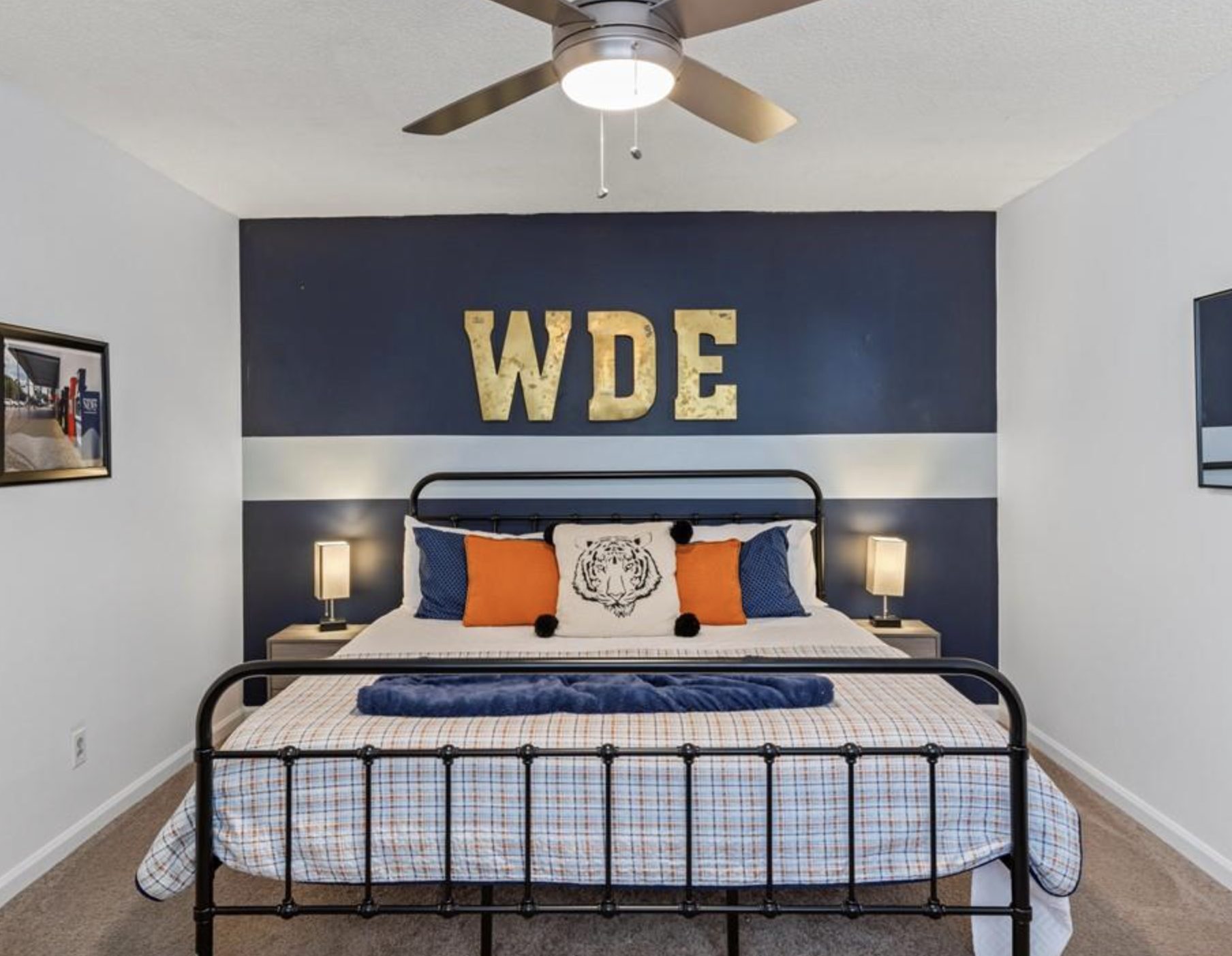 Bedroom interior of Auburn student condo featuring Auburn University decor in Auburn Alabama