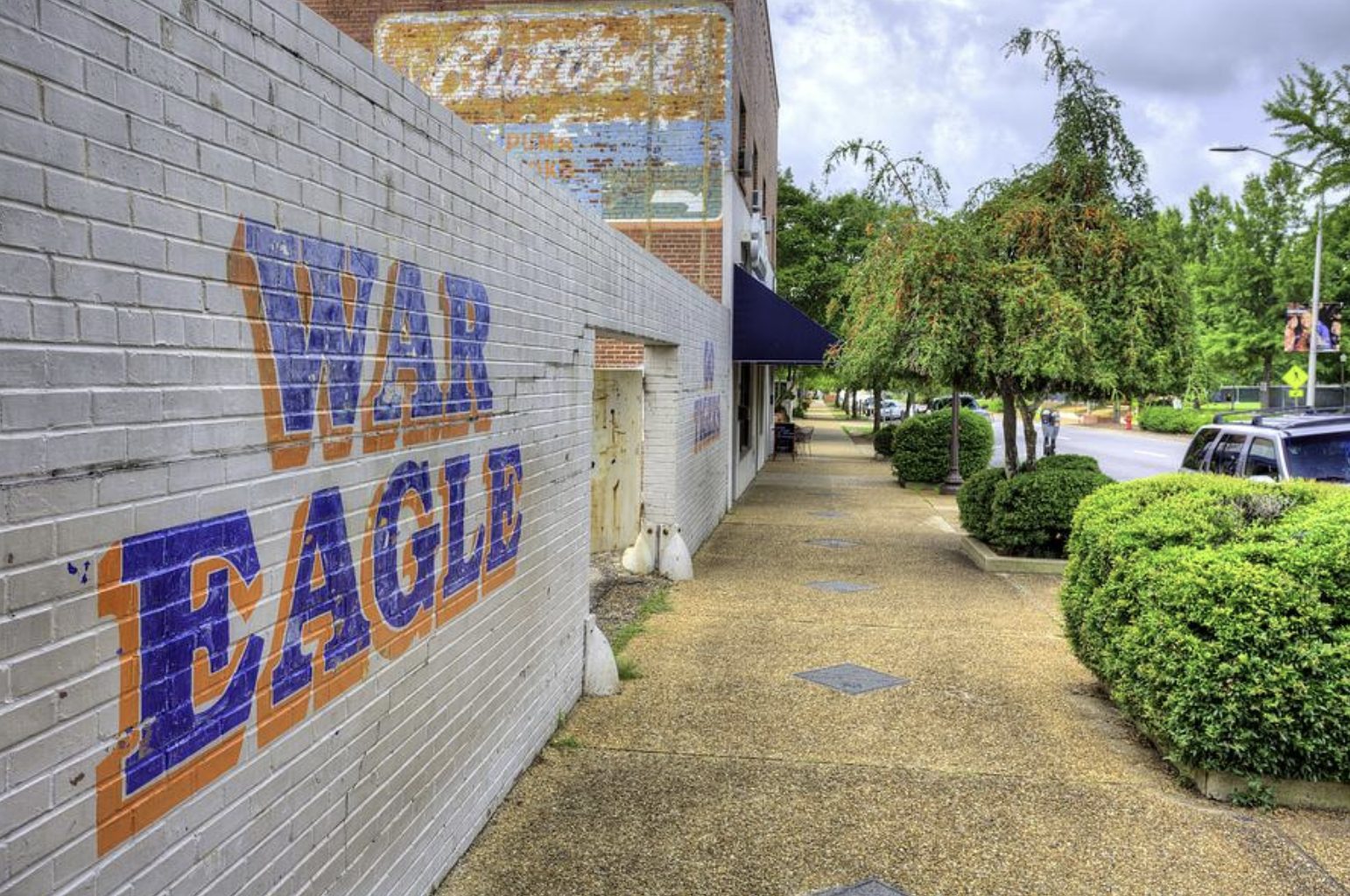 Downtown Auburn Alabama sidewalk with War Eagle mural representing local lifestyle and living in Auburn Alabama.