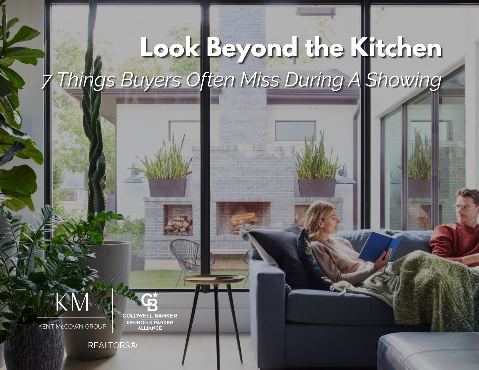 Couple relaxing in a bright living room with large windows overlooking an outdoor living space. Text overlay reads, "Look Beyond the Kitchen: 7 Things Buyers Often Miss During a Showing." Kent McCown Group and Coldwell Banker Kennon & Parker Alliance logos displayed at the bottom.