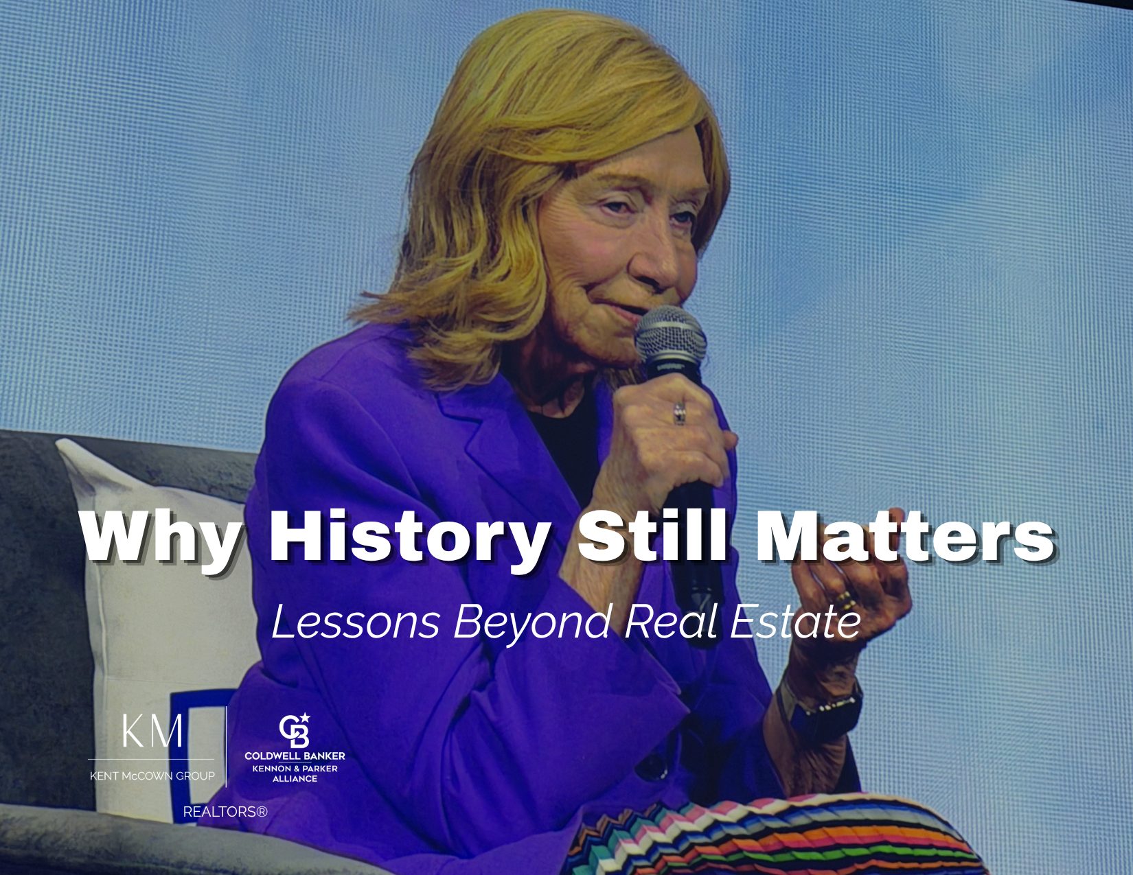 Doris Kearns Goodwin speaking at the National Association of REALTORS conference in a bright purple blazer and colorful patterned skirt, illustrating lessons about leadership, history, and why understanding the past matters beyond real estate.